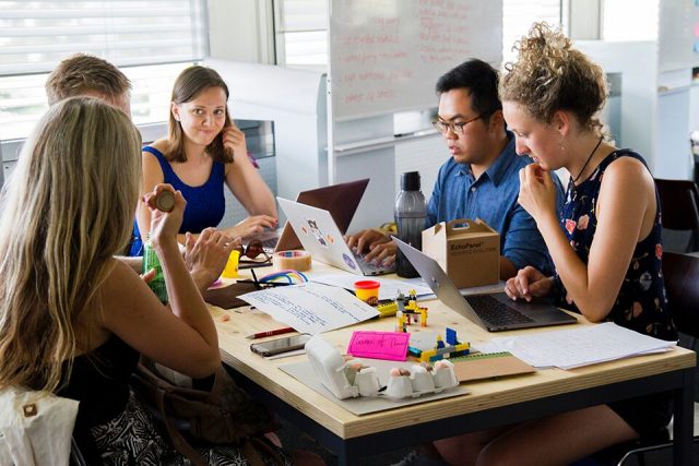 a group of students sitting at a table revising