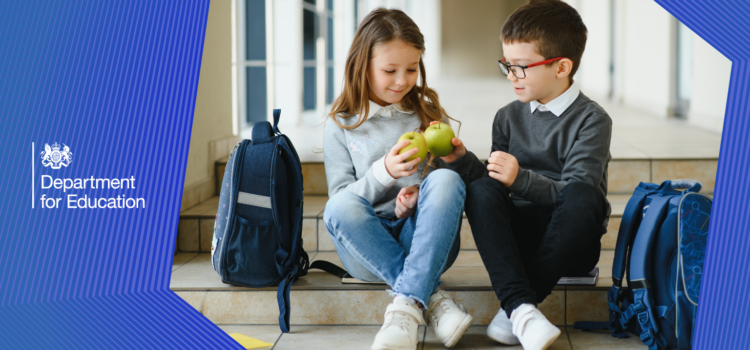 Children sat eating an apple